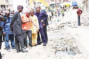 Lagos State governor, Babatunde Fashola inspecting a sanitation exercise in Lagos