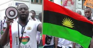 Uchenna Madu with MASSOB flag