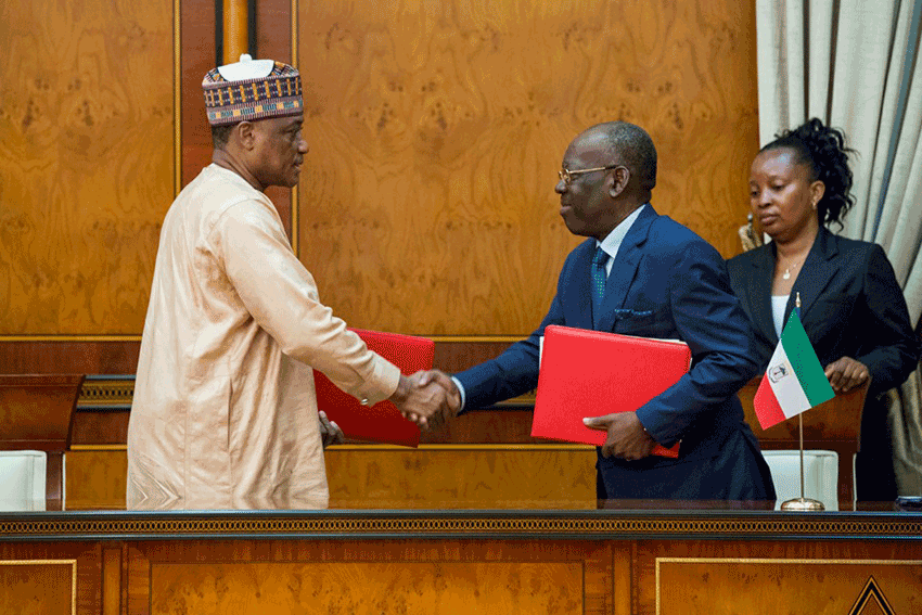 Minister of Defence Dan Mansur Ali and his Equitorial Guinea counterpart exchange copies of agreement